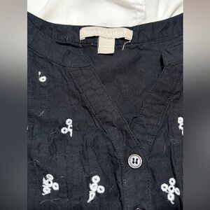 Woman Within Black Top with White Floral Embroidery